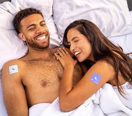 Couple wearing the Klova Sleep ZPatch in bed