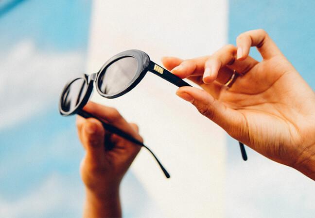 Crap Eyewear sunglasses held against a bright California sky
